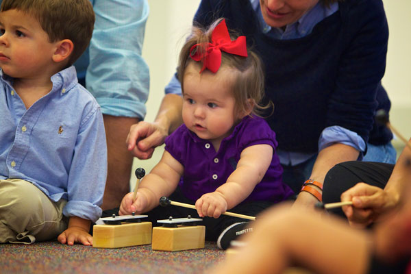 A little girl exploring music music instrument for the first time